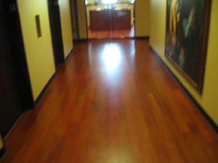 Brazilian cherry hardwood floor installation in a Houston hallway Glossy Brazilian cherry hardwood floor in a Houston hallway