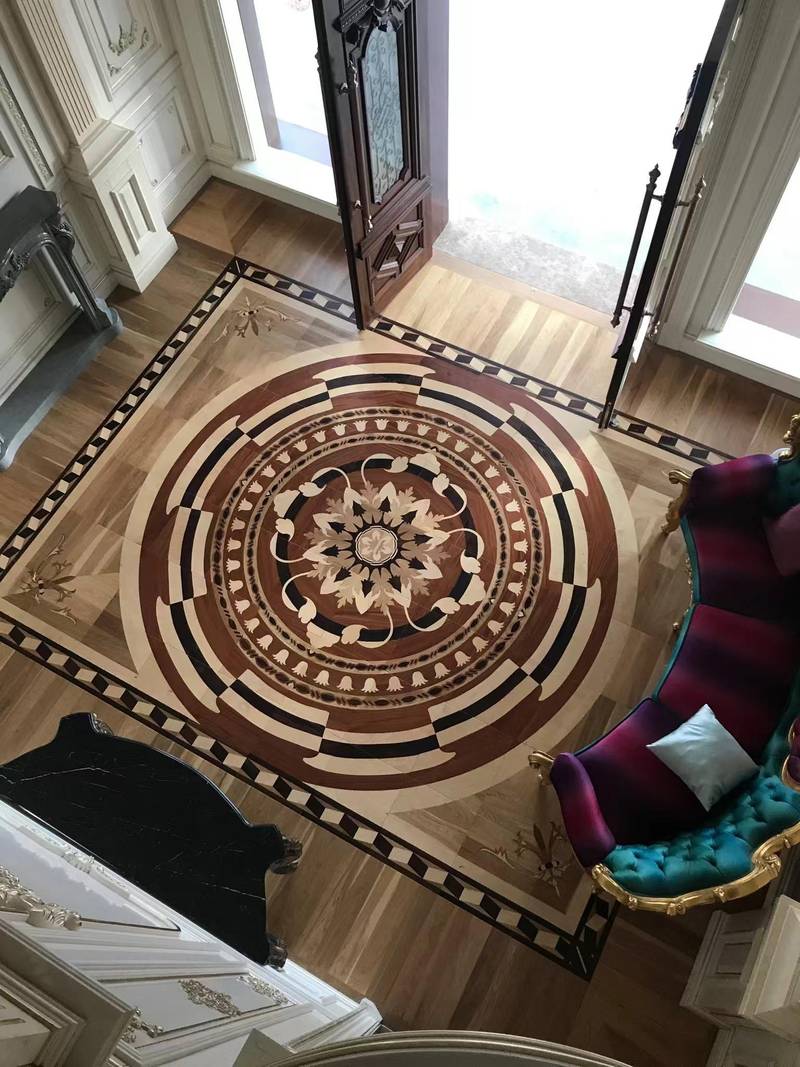 Custom wood-on-wood floor medallion Ornate wood-on-wood entry floor medallion with circular floral inlay and patterned border