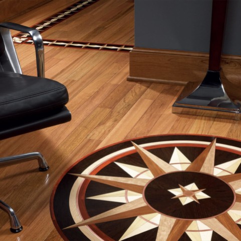 Hardwood floor with custom compass medallion inlay and metal accent border