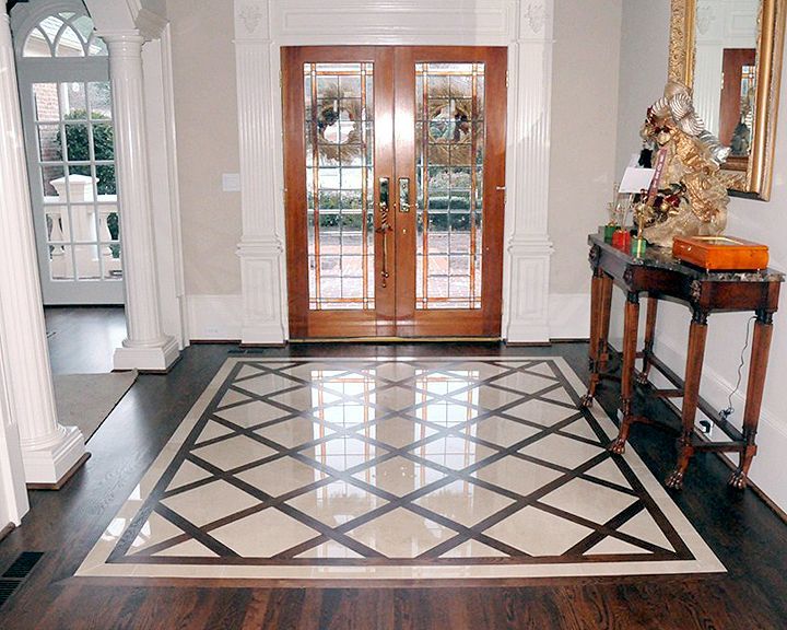 Custom wood floor with tile inset Entry floor with glossy tile inset framed by dark hardwood and light border trim
